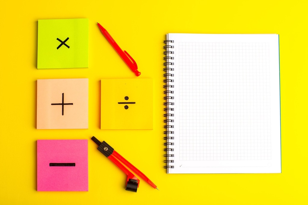 Material escolar com blocos de anotações com sinais de operações matemáticas