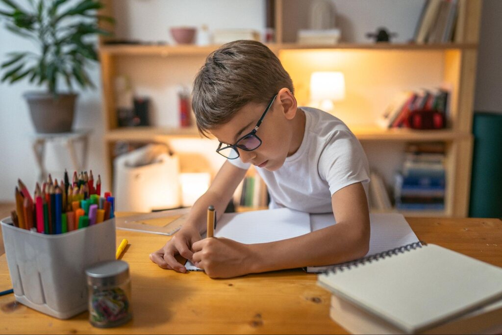 aluno praticando exercícios no caderno depois de fazer o Kumon de matemática