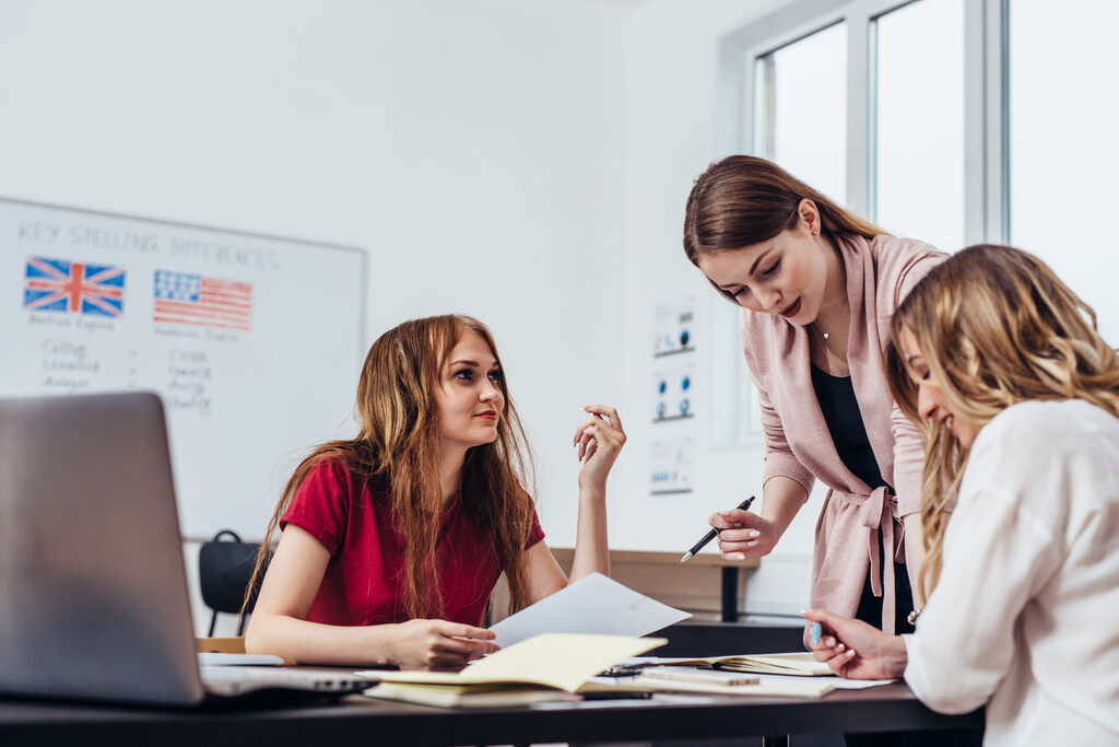 Três mulheres estudando sobre diferença entre níveis de inglês.